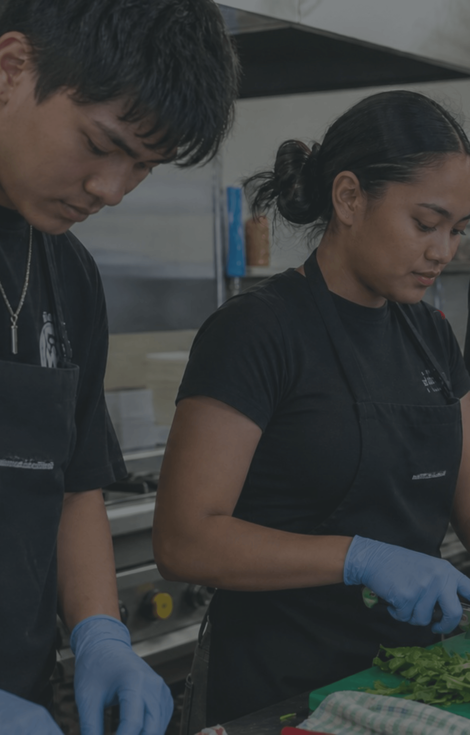 pacific-maori-young-team-kitchen-food-prep-aprons-gloves-dark-overlay-nz